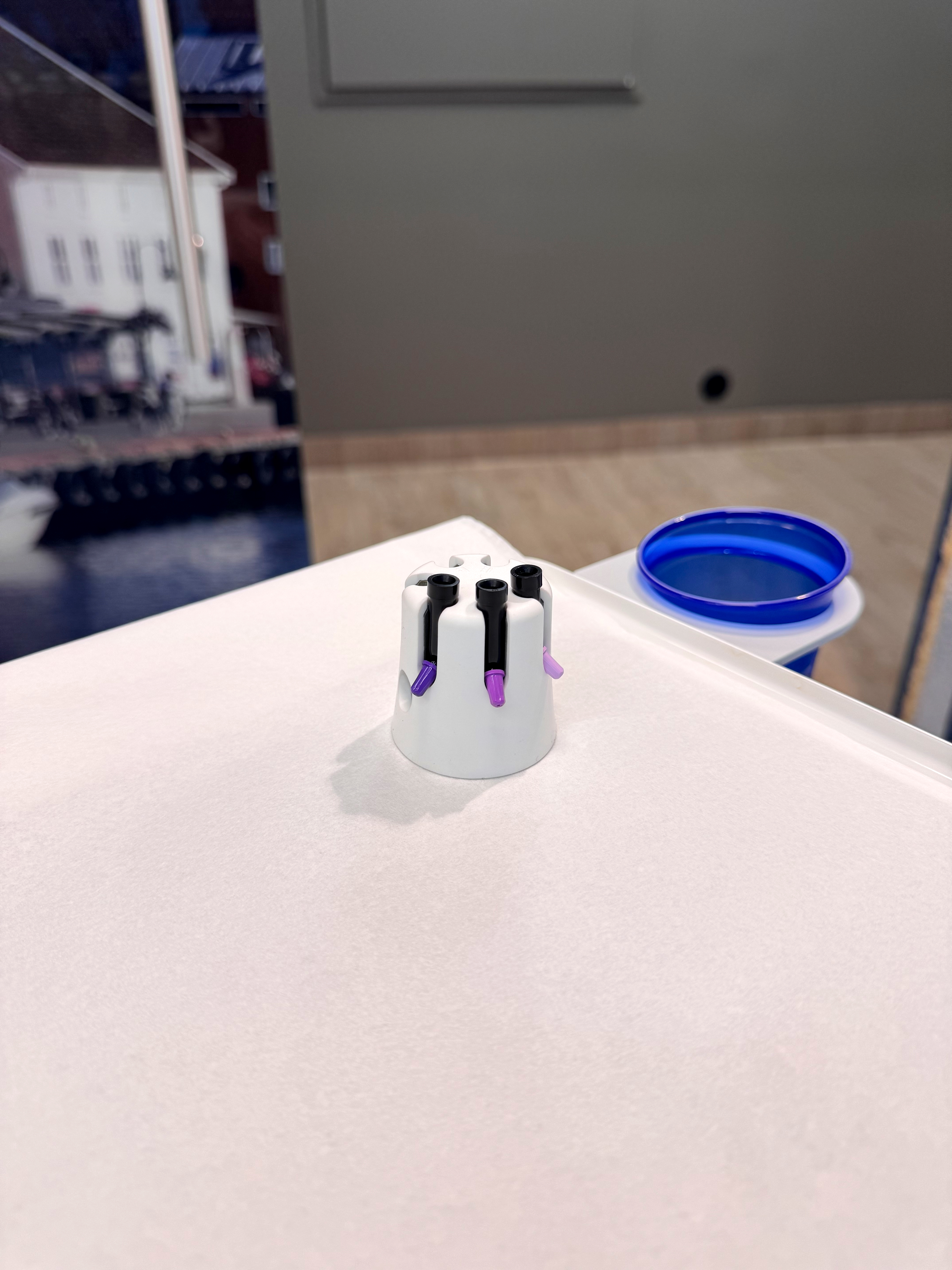 A composite warmer on a plain white countertop in a practice